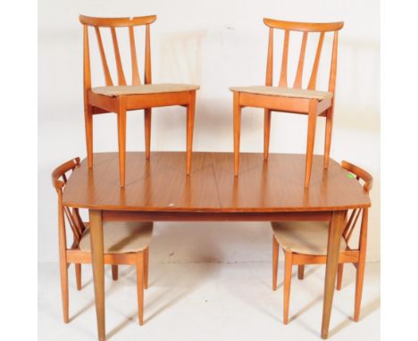 A retro vintage mid 20th century circa 1960s teak wood dining table and chairs. The table is of rectangular form with bowed s