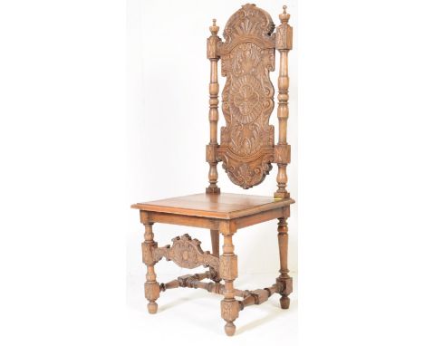 A Victorian 19th century Carolean revival carved oak hall chair. Having a tall long carved back rest with central panel with 