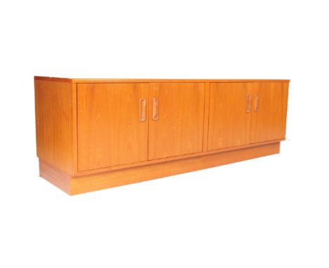 A retro vintage mid 20th century teak sideboard credenza. Rectangular form with two twin cupboard doors with shelved interior