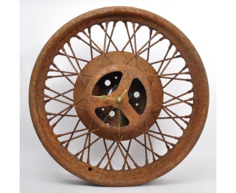 Cast metal wall clock converted from a vintage spoked car wheel. Modern quartz movement fitted to centre with gold coloured h