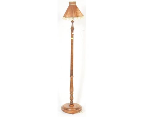 An early 20th century circa. 1920's mahogany floor standing standard lamp. The lamp having turned wood shaft over a circular 