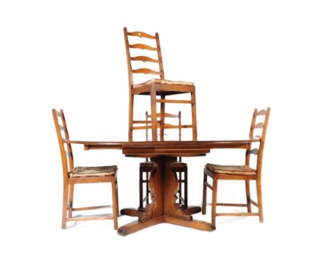 Ercol Furniture - A 20th century Ercol beech and elm wood dining room suite. The suite having an extending circular table top