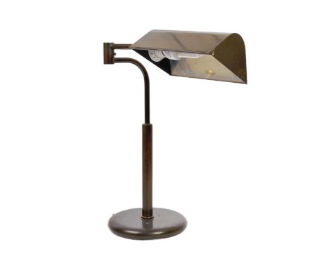 A retro vintage 20th century metal articulated swivel arm industrial table desk lamp. The lamp having a shaped concave shade 