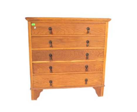 A 1930's Art Deco golden oak chest of drawers. The chest being raised on bracket feet with an upright body of five drawers ha