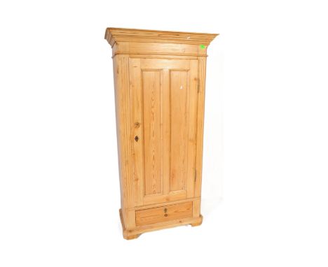 A 20th century Scandinavian sentry box pine single wardrobe armoire. Of good size, the wardrobe being raised on block feet wi