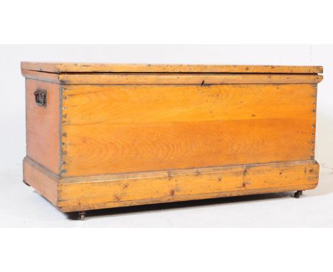 A Victorian 19th century country pine blanket box chest. Raised on castors to a plinth base having panel sides with handles e