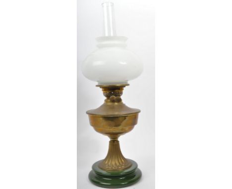 A Victorian 19th century brass and opaline glass oil lamp. The oil lamp having green stepped base over moulded gadrooned base