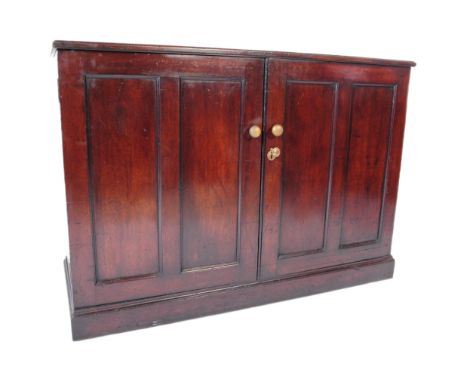 19th century Victorian mahogany school cupboard. Raised on a plinth base with twin fielded panel doors having brass handles w