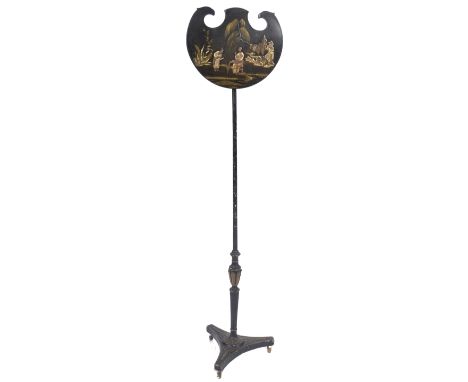 A 19th century Regency black lacquered pole screen having a shaped panel with&nbsp;chinoiserie scene of figures with a villag
