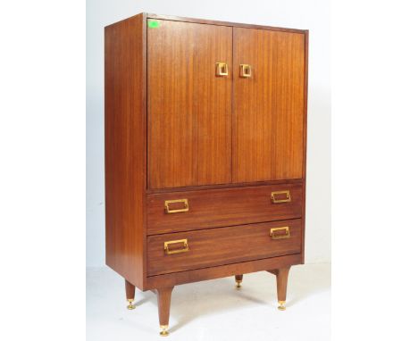 A vintage retro mid 20th century circa 1950’s teak wood wardrobe by Ernest Gomme for G-Plan. The wardrobe having twin doors o