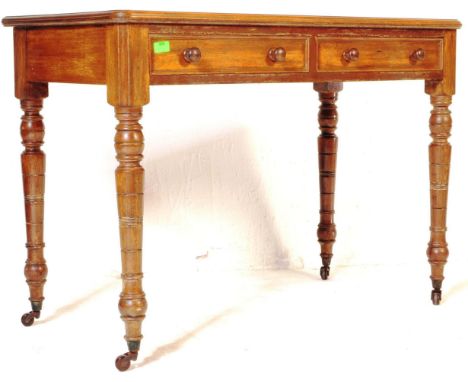 A&nbsp; Victorian 19th century mahogany writing table desk. Raised on ring turned legs with twin drawers to the frieze having