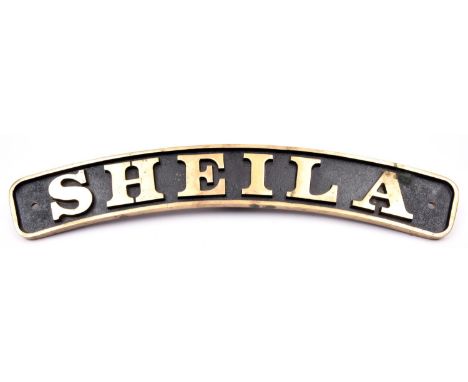 A brass locomotive or traction engine nameplate 'Sheila'. A substantial plate with deeply cast letters and a black painted ba