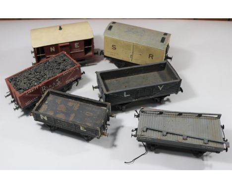 6x O gauge coarse scale kit-built freight wagons. An SR refrigerator box van in white. An NER guard's van. 3x open wagons; L&