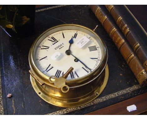 A 20cm diameter antique brass ships bulkhead clock by Cooke of HullCONDITION REPORTwinds up and keeps time