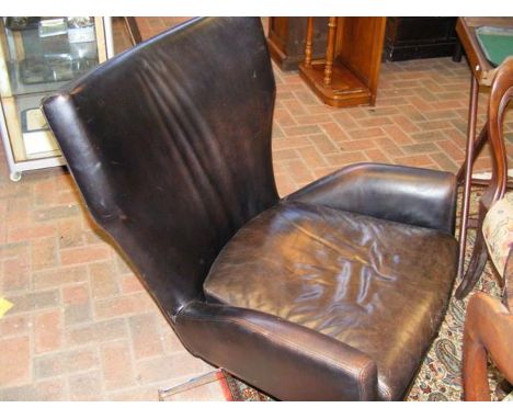 A vintage style brown leather and chrome swivel chair, manufactured by West Elm