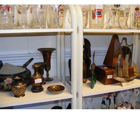 A metronome, brass gong and various figures, together with various eastern brass ware - on two shelves  