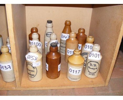 Twelve vintage Isle of Wight stoneware bottles including Riddick &amp; Sons, Brading and Bembridge