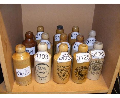 Thirteen vintage Isle of Wight stoneware bottles including Randall, Taplin &amp; Co.