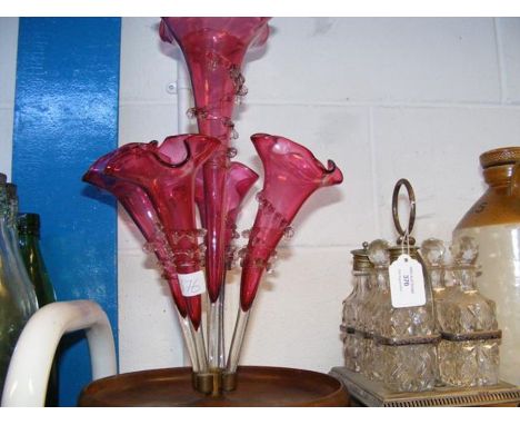 A cut glass condiment set on plated stand together with a cranberry glass epergne