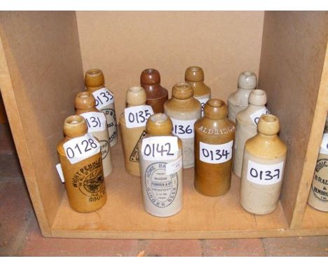 Twelve vintage Isle of Wight stoneware bottles including ginger beer Flander &amp; Co, Newport