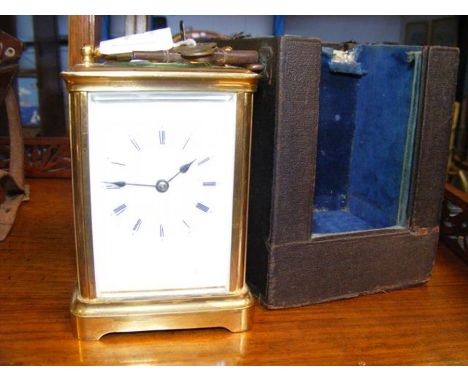 A 15cm high brass cased carriage clock in travelling case