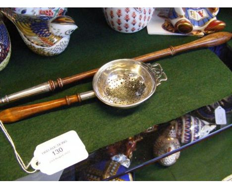 A silver toddy ladle together with strainer