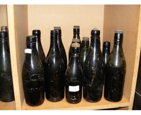 Fourteen vintage Isle of Wight glass bottles including Bishop of Ryde and others