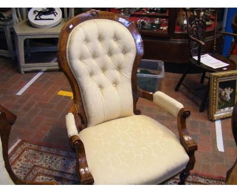 A Victorian armchair with button back and turned front supports