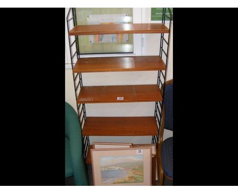 A narrow ladder rack style bookcase - 64cm wide, together with four Isle of Wight related pictures