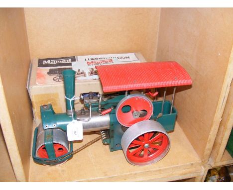 A Mamod steam engine, together with a boxed lumber wagon 