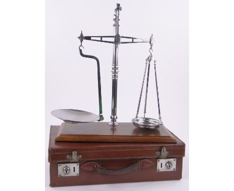 A pair of chrome plate bank scales,inscribed Cooperative Wholesale Society, on mahogany plinth base, length 18", height overa