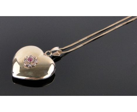 A 9ct gold ruby and diamond set heart shaped pendant,on 9ct chain, height excluding bale 25mm, gross weight 4.1g