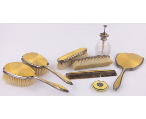 An 9-piece silver and yellow enamel dressing table set,by Mappin & Webb including cut-glass atomiser scent bottle and compact