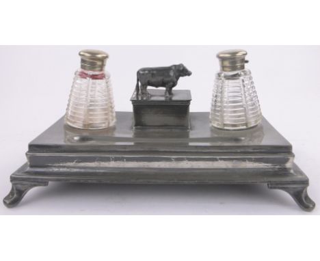 A Victorian pewter desk stand,with cut-glass milk churn shaped inkwells, length 12".