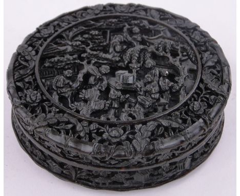 A Chinese circular tortoiseshell snuff box,with intricate relief carved garden scenes with figures and pergolas, diameter 3.5