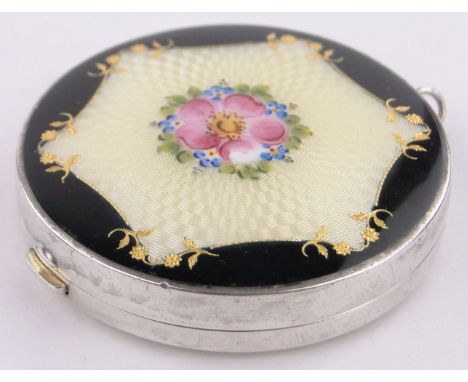A circular sterling silver and coloured enamel miniature compact,with painted floral spray, diameter 5cm.