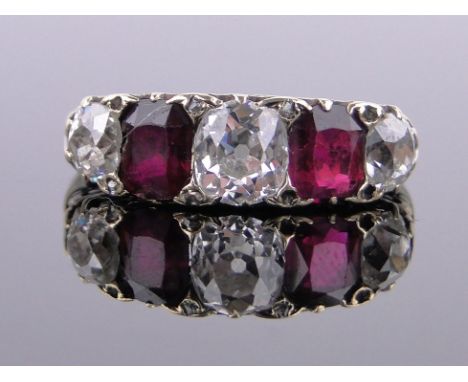A 5 stone ruby and diamond ring,circa 1920, central diamond approx 0.6cts, total diamond content approx 1.2cts, in carved set