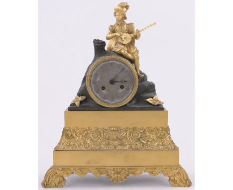 A 19th century French ormolu cased mantel clock,with engraved silvered dial surmounted by a figure playing a mandolin, height