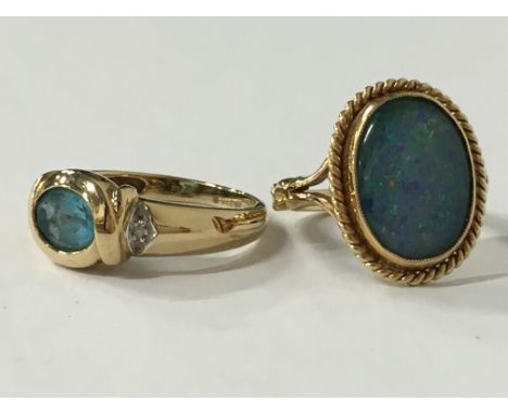 A 9 carat gold opal triplet set ring (size K) together with a 9 carat gold blue topaz and diamond set ring (size M).