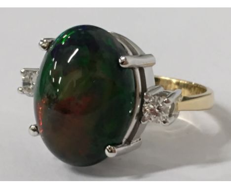 An 18 carat gold natural black opal set ring (size Q).
(R3A)