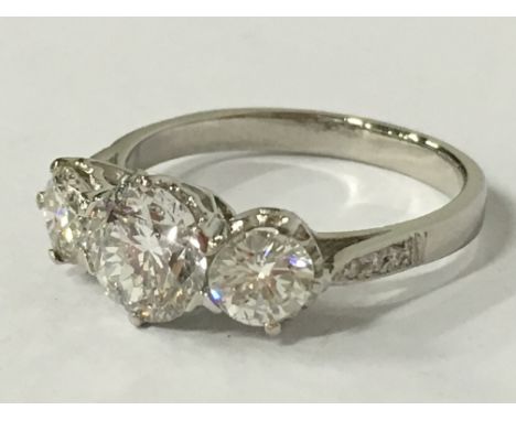 A platinum and diamond three stone ring (TDW 2.55 Cts), (size M).