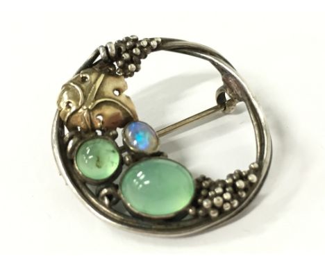 A Sybil Dunlop gold and silver brooch set with an opal and Chrysoprase.
(R1)