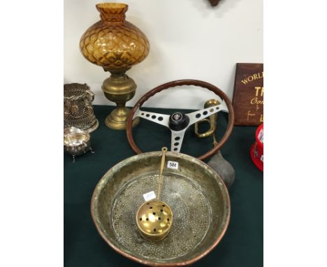 A mid 20th century automobile steering wheel together with a brass car horn, oil lamp, copper bowl and miniature brass chestn