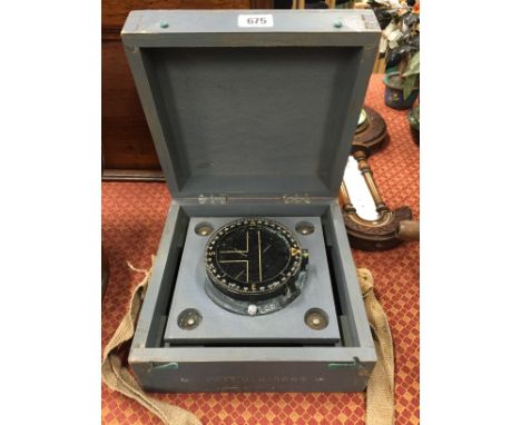 A mid 20th century Naval compass in original wooden carrying box.
