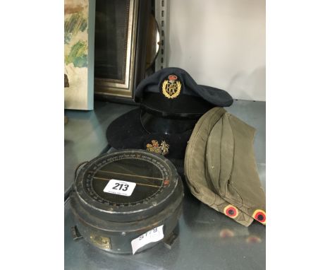 Four various servicemen caps together with a military compass (examine).