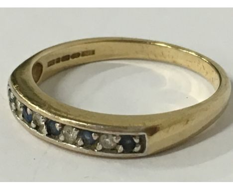 A 9 carat gold diamond and sapphire half eternity ring (size O).
(R14)