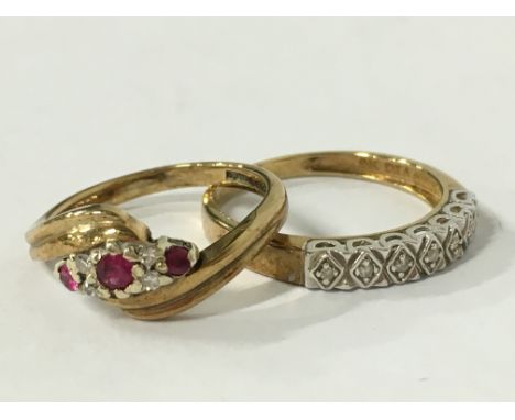 A 9 carat gold seven stone diamond ring together with a 9 carat gold ruby and diamond ring.