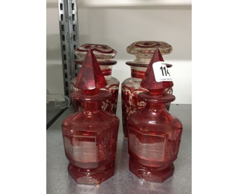 A pair of Bohemian etched ruby glass scent flasks (both af) together with two red painted glass spice jars.
(R52)