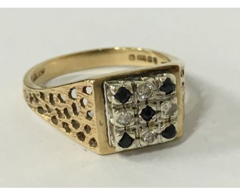 A 9 carat gold diamond and sapphire set ring (size O).