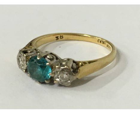 An 18 carat gold natural blue zircon and diamond ring (size M).